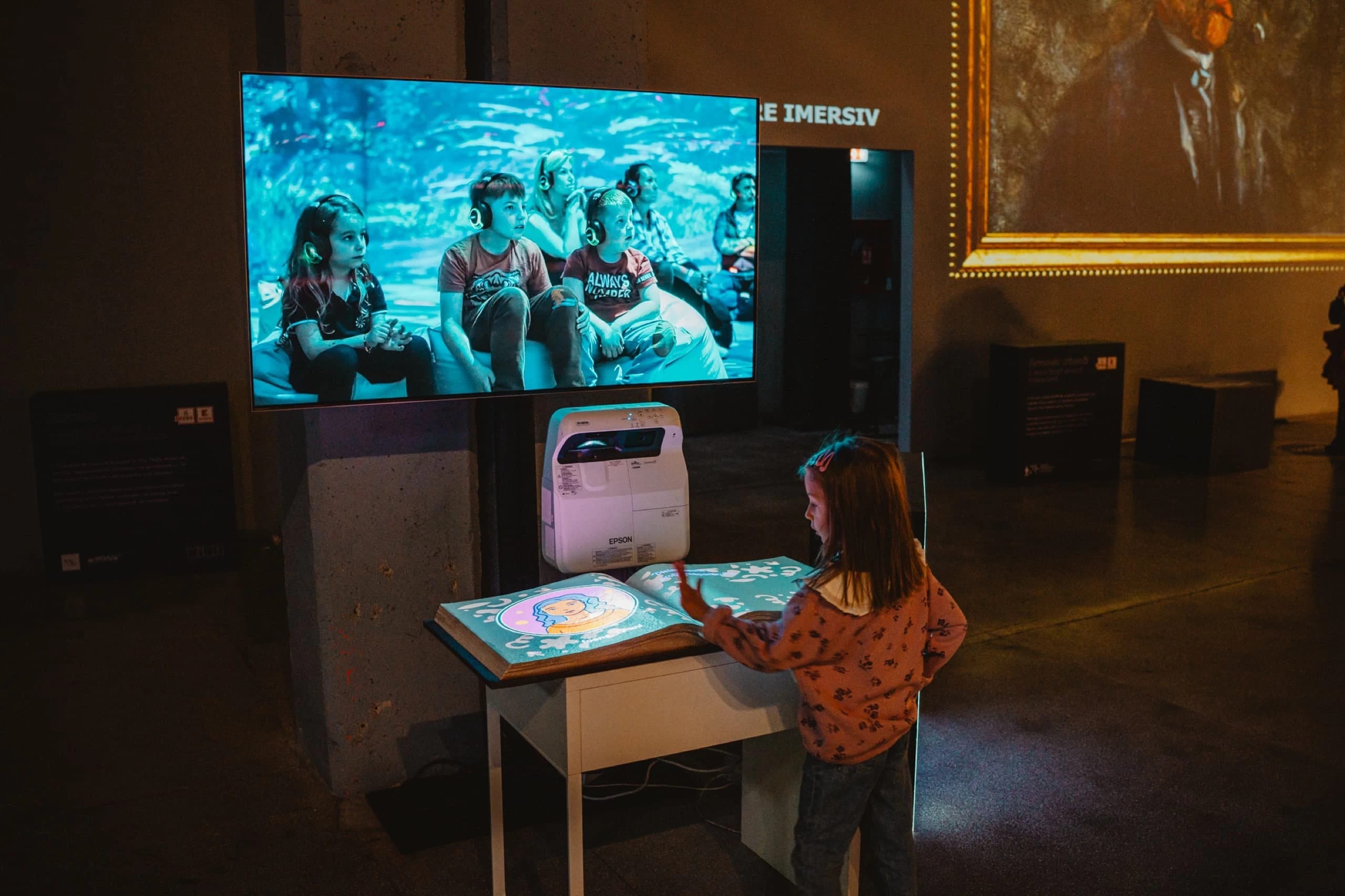 A school class walks through a projected prehistoric forest